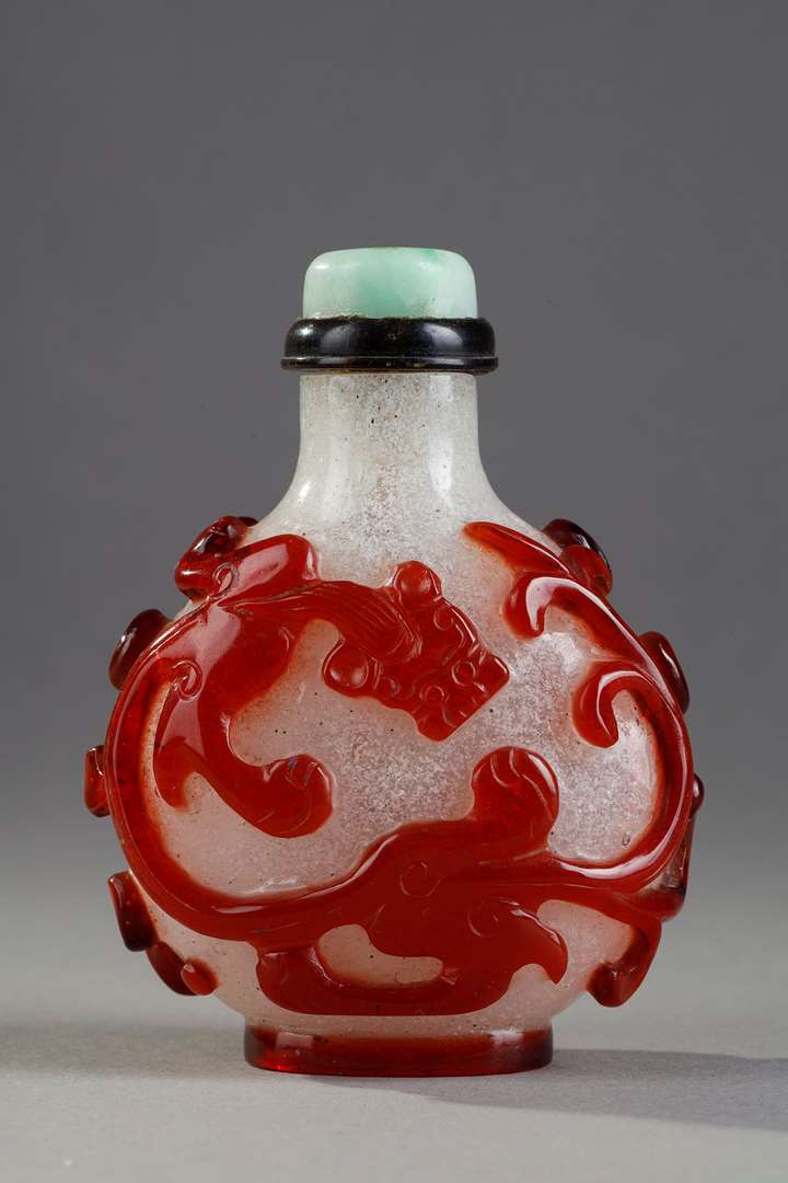 Beautiful red glass snuffbottle overlay on bully background adorned on each side of a dragon shi China 1750/1820